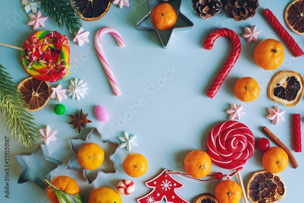 Fototapeta Christmas or New Year composition with candy cane, fir branch and tangerines