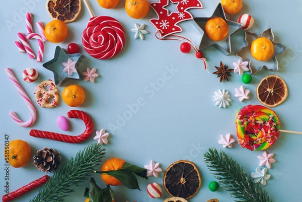 Fototapeta Christmas or New Year composition with candy cane, fir branch and tangerines