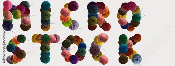 Fototapeta Microstock text made of balls of wool colored yarn for hand knitting on white background. Flat lay, copy space, banner.