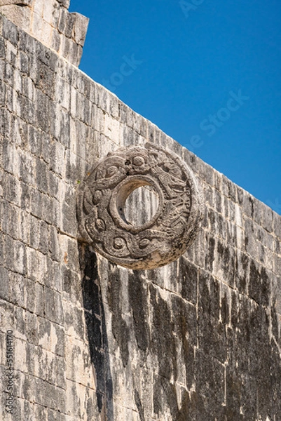 Fototapeta A large stone ring set on a high wall for a traditional Mayan ball game. Archaeological area of the Chichen Itza pyramids in Mexico.