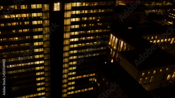 Fototapeta Aerial night view of an office building. The lights are on.