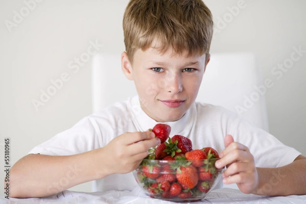 Fototapeta little funny boy with strawberries