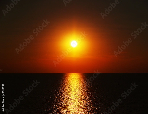 Fototapeta red sunset in the dark sea