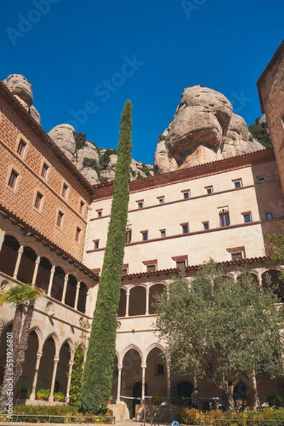 Fototapeta Vertical shot of the Abbey of Montserrat building in Barcelona, Spain against a blue sky