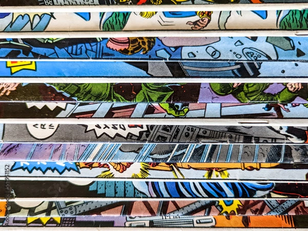 Fototapeta Vintage comic book collection stacked in a pile creates background pattern of colorful lines and shapes on old paper
