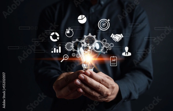 Fototapeta Businessman showing light bulb with business idea planning development leadership and customer target group, investment growth and success development, achievement, goal, strategy, finance concept.