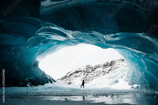 Fototapeta Person is standing in beautiful ice cave in Vatnajkull glacier Iceland in the winter