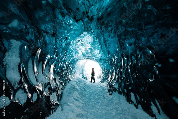 Fototapeta Person is standing in beautiful ice cave in Vatnajkull glacier Iceland in the winter
