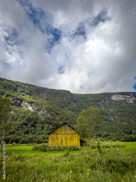 Fototapeta old yellow house in the mountains