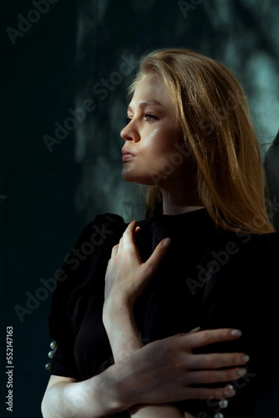 Fototapeta Dramatic Portrait Of Beautiful Elegant Lady With Trees Shadows At Her Face And Background. Actress Showing Mourning Widow Or Sadness