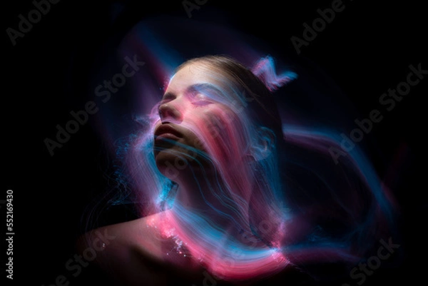 Fototapeta Abstract photography in the style of light painting. girl on a black background