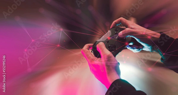Fototapeta gamer player with joystick to play a game, digital online gaming streaming, e-sports challenge, technology for entertainment