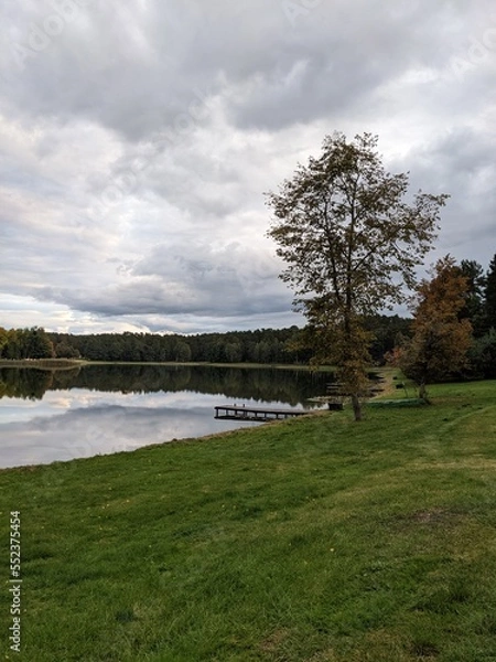 Obraz picturesque lake view with small bridge and reflections
