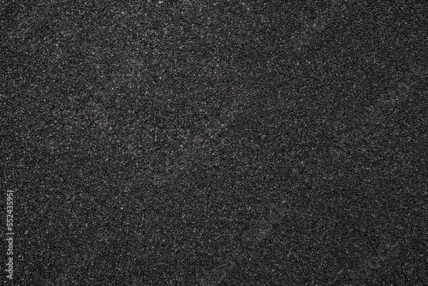 Fototapeta The texture of dense black foam rubber.The background of the foam is black.The substrate is made of black foam rubber.