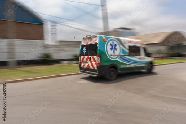 Fototapeta Ambulance in a rush passing at high speed