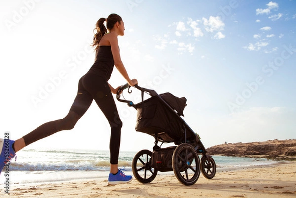Obraz Beautiful mom and son doing a morning jogging on the beach.
