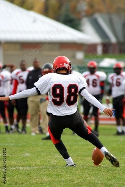 Fototapeta American football kickoff view from behind. ..