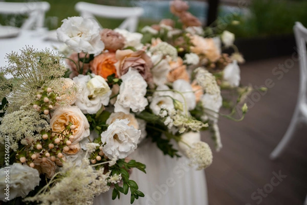 Fototapeta Main table at a wedding reception with beautiful fresh flowers. Outside wedding decorations.