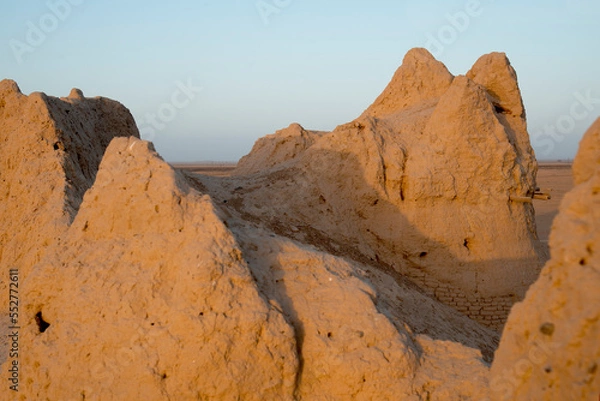 Fototapeta Part of an ancient clay wall in the golden hour. South Kazakhstan, Sauran fortress