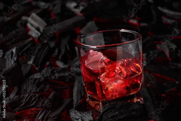 Fototapeta  Whiskey with ice  on a background of burning charcoal.