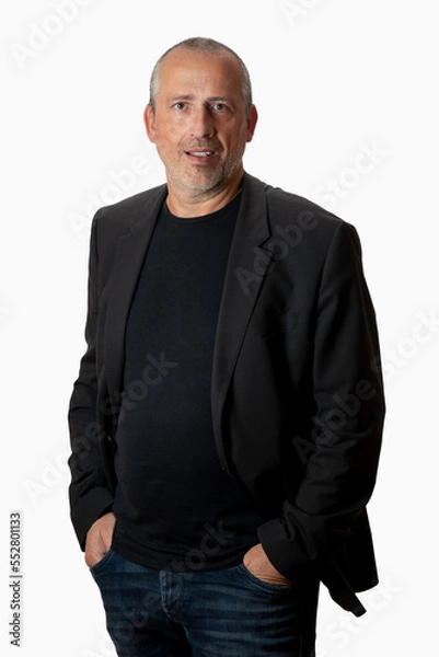 Fototapeta portrait of a handsome middle-aged man looking straight in the camera, waist down, hands in the pockets.