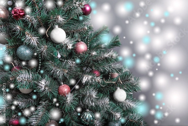 Fototapeta Christmas tree with branches sprinkled with hoarfrost and elegantly decorated with Christmas balls, beads, garlands.Horizontal, closeup