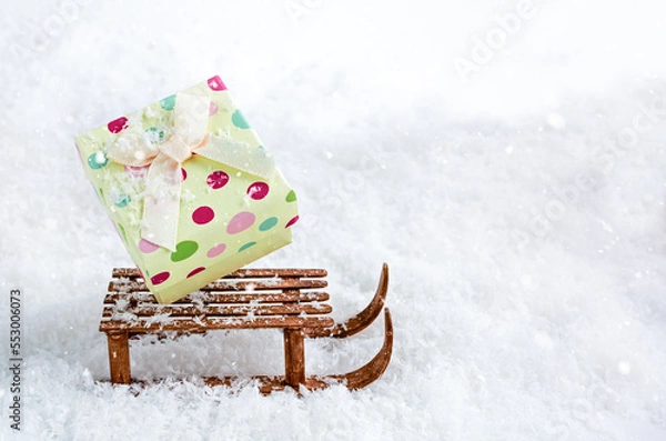 Obraz box of gifts on a sled in the snow