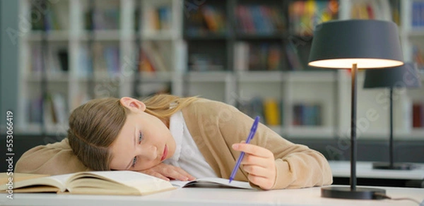 Fototapeta School girl at boring lesson playing with pen