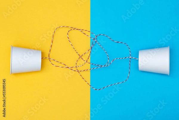 Obraz Implementing the concept of a communication system using white paper cups and strings