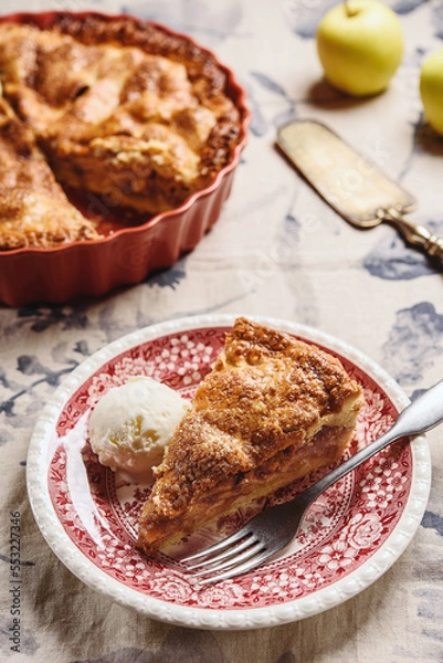 Fototapeta Classic American apple pie served with ice cream on linen tablecloth. Homemade american autumn dessert: sliced apple pie (tart) with cinnamon. Selective focus