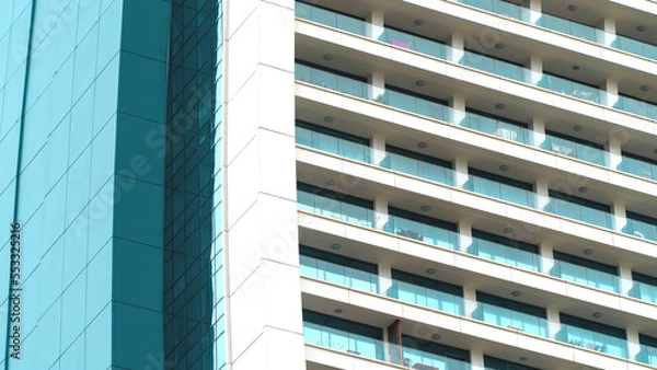 Fototapeta Details of high rise building. Residential house exterior. Low angle view. Selective focus included. Noise and grain included.