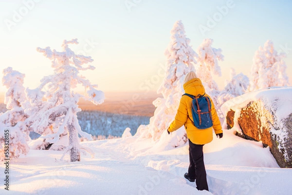 Obraz Young woman in winter forest in Finland