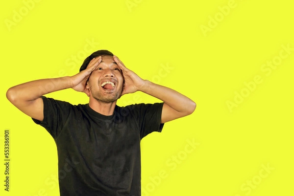 Obraz A frustrated man with a yellow background