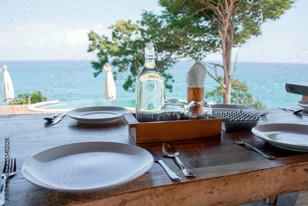 Obraz served table in a cafe overlooking the ocean