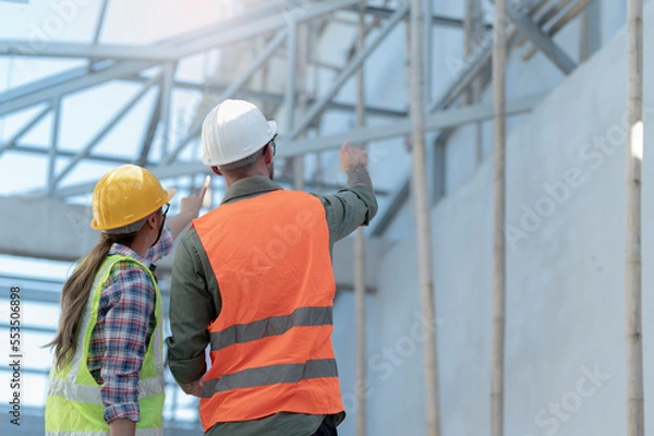 Obraz Young men and women inspecting new buildings.