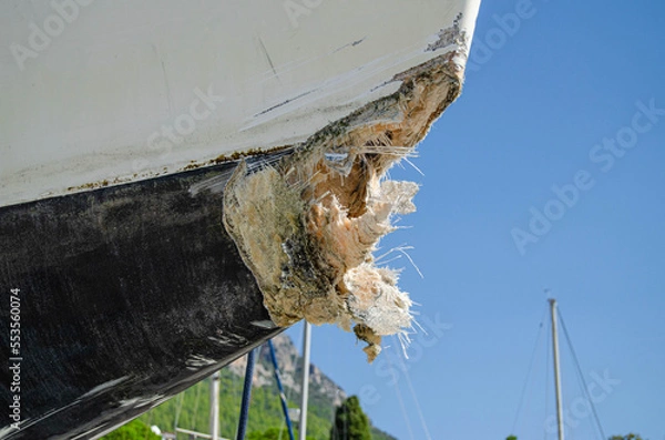 Obraz The collision-damaged bow of the fiberglass yacht.