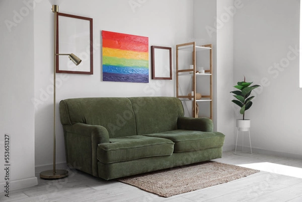 Fototapeta Interior of living room with sofa, frames and rainbow painting