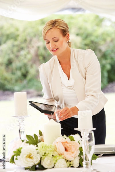 Obraz Wedding Planner Checking Table Decorations In Marquee
