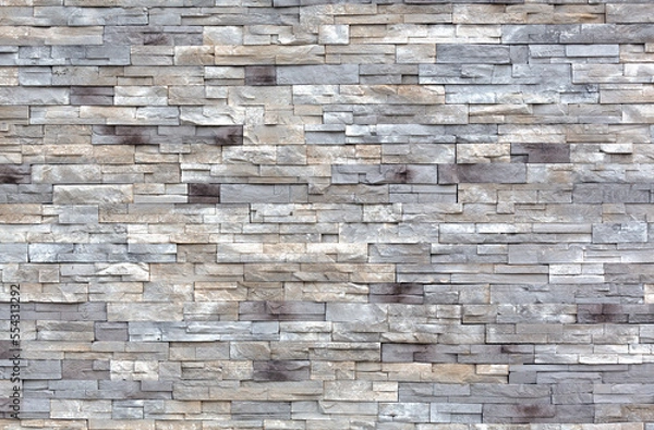 Obraz Rows of gray and white cut stone blocks for an exterior wall wide view.