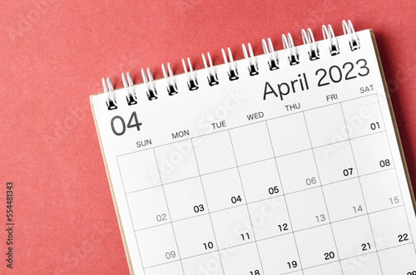 Fototapeta A April 2023 calendar desk for the organizer to plan and reminder isolated on red background.
