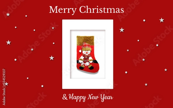 Obraz Christmas card with a red gift sock and a snowman in a red checkered hat on a red backdrop. The sock is in the white frame and there're are stars and snowflakes around. It can be used in print, web...