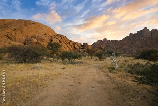 Fototapeta Sunrise in calm morning in Spitzkoppe, panoramic, desert landscape of famous red, granite rocks, Namibia, Africa 