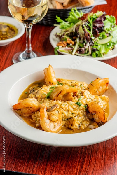 Obraz Shrimp and Grits. Grits and old bay seasoned jumbo shrimp topped with spices and micro greens. Classic American Diner Style Breakfast or Brunch menu item. Traditional low country southern staple. 