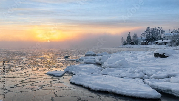Obraz Frosty morning and freezing sea at sunrise