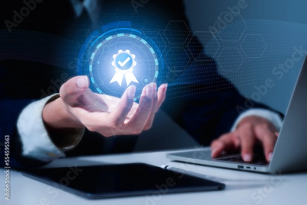 Obraz The hand of a businessman represents the quality assurance 5 star, guarantee, standards, ISO certification, and standardization concept.