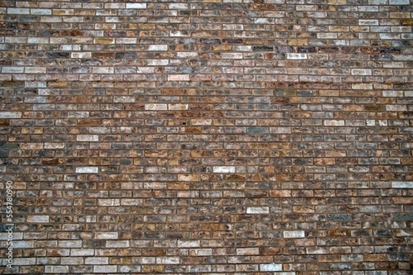 Fototapeta The wall is lined with multicolored kirpich