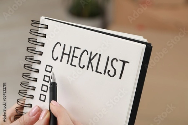 Obraz Woman filling Checklist with pen, closeup view