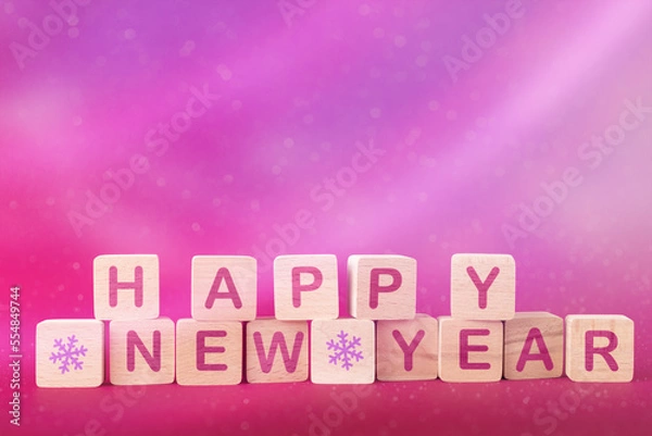 Fototapeta Wooden blocks with words Happy New Year over pink abstract Christmas background