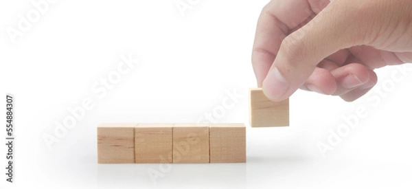 Fototapeta Wooden cubes in hand with copy space for input wording