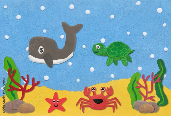 Fototapeta happy sea life animal made from plasticine on sand and sea under water background